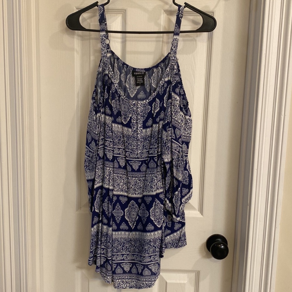 Navy blue and white with pattern. Cold shoulder, with a loose fit.